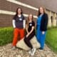 Three healthcare staff members in scrubs standing together outside Pawnee Valley Community Hospital